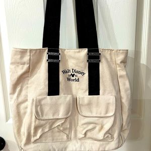 Disney World Tote tan canvas with black straps, front pockets & top snaps closed